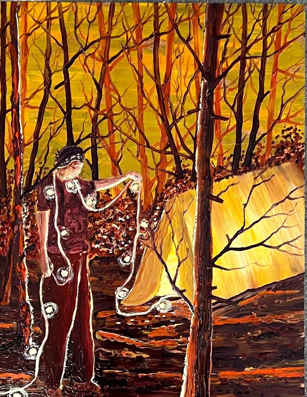 Figure standing in a forest beside a glowing tent while holding a strand of illuminated spheres.